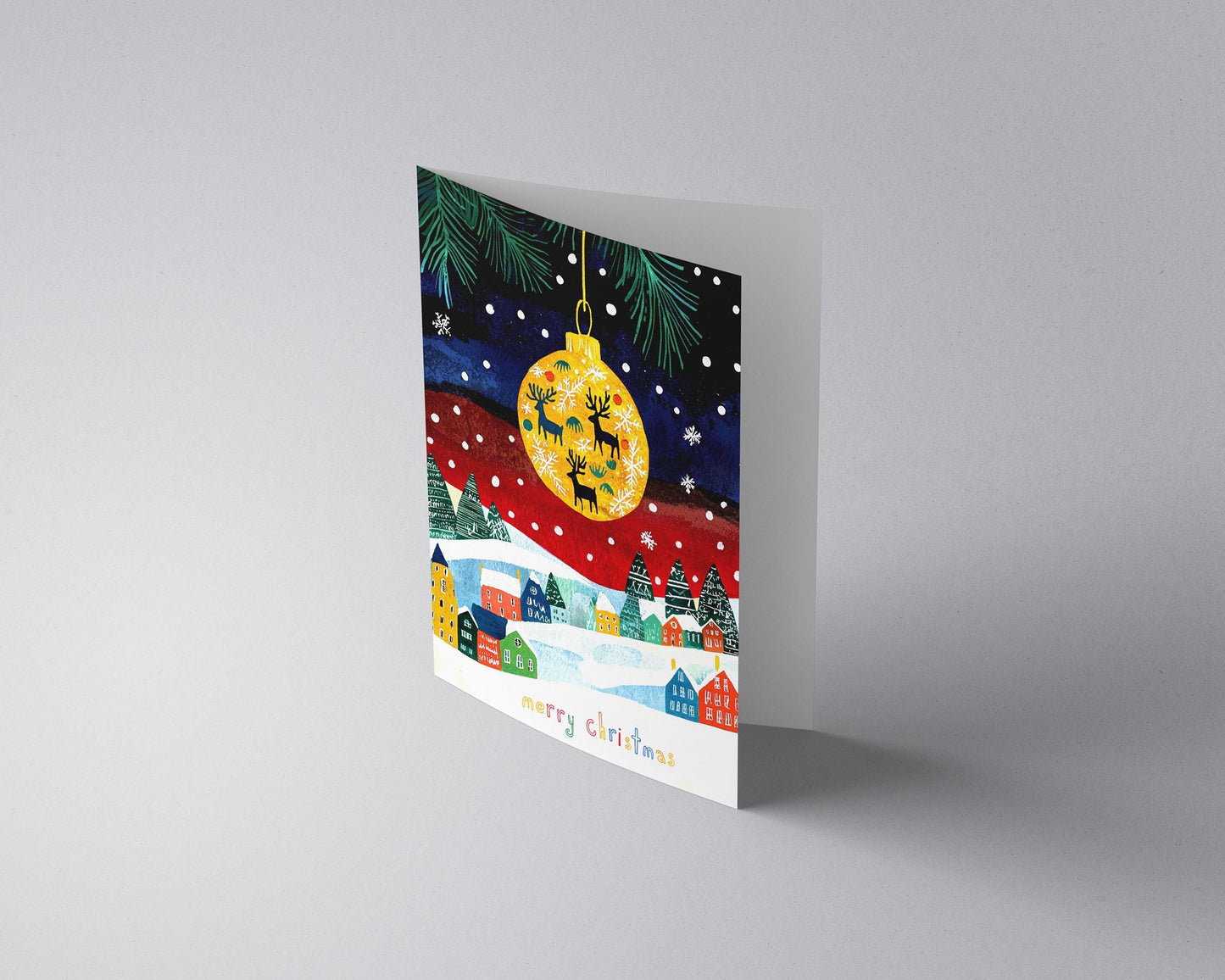 Holiday Card with Snowy Village Scene Christmas Ornament Reindeer Silhouette Colorful Houses Whimsical Design