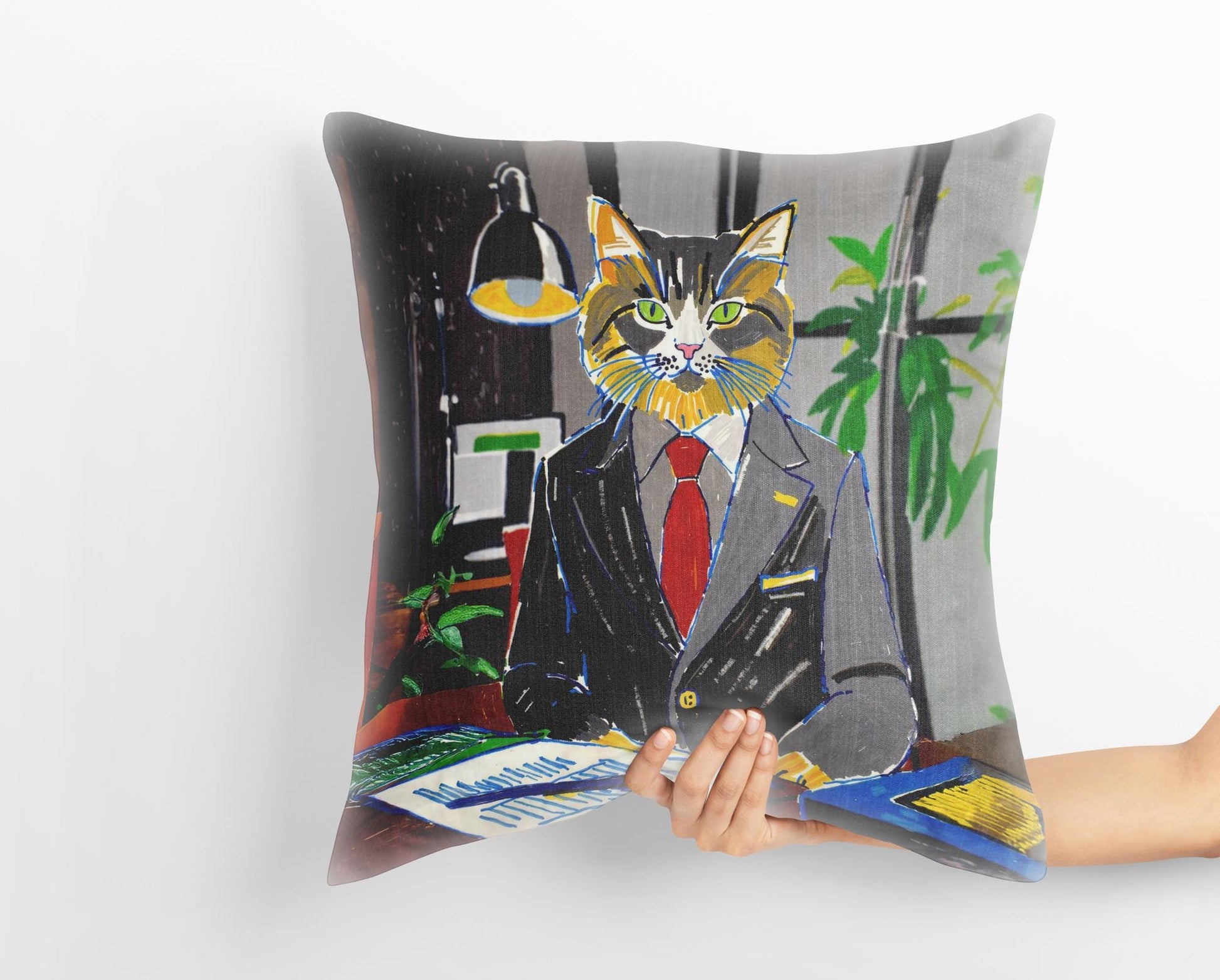 A hand holds a custom medieval pet portrait pillow featuring a calico cat dressed in a business suit, standing in an office setting. The whimsical art adds a touch of humor and sophistication.