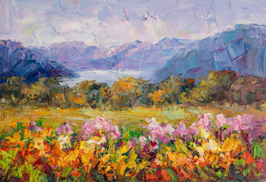 Hand-painted oil landscape of a vibrant mountain meadow with pink, yellow, and green flowers; distant blue mountains under soft purple sky; unframed canvas on neutral surface