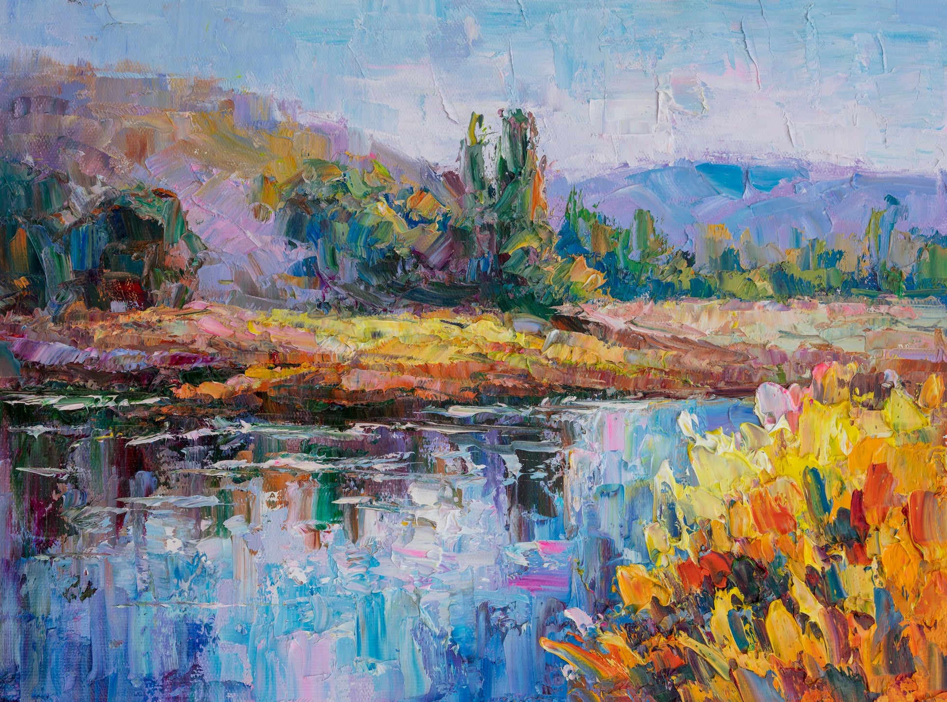 Impasto oil painting of a vibrant river landscape with bold blue, green, and yellow strokes; unframed canvas on neutral surface, horizontal composition