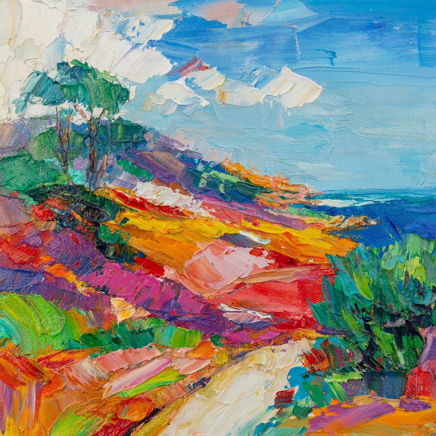 Hand-painted coastal landscape in vibrant oil on canvas, unframed, featuring bold brushstrokes and a colorful hillside leading to the sea under a bright sky