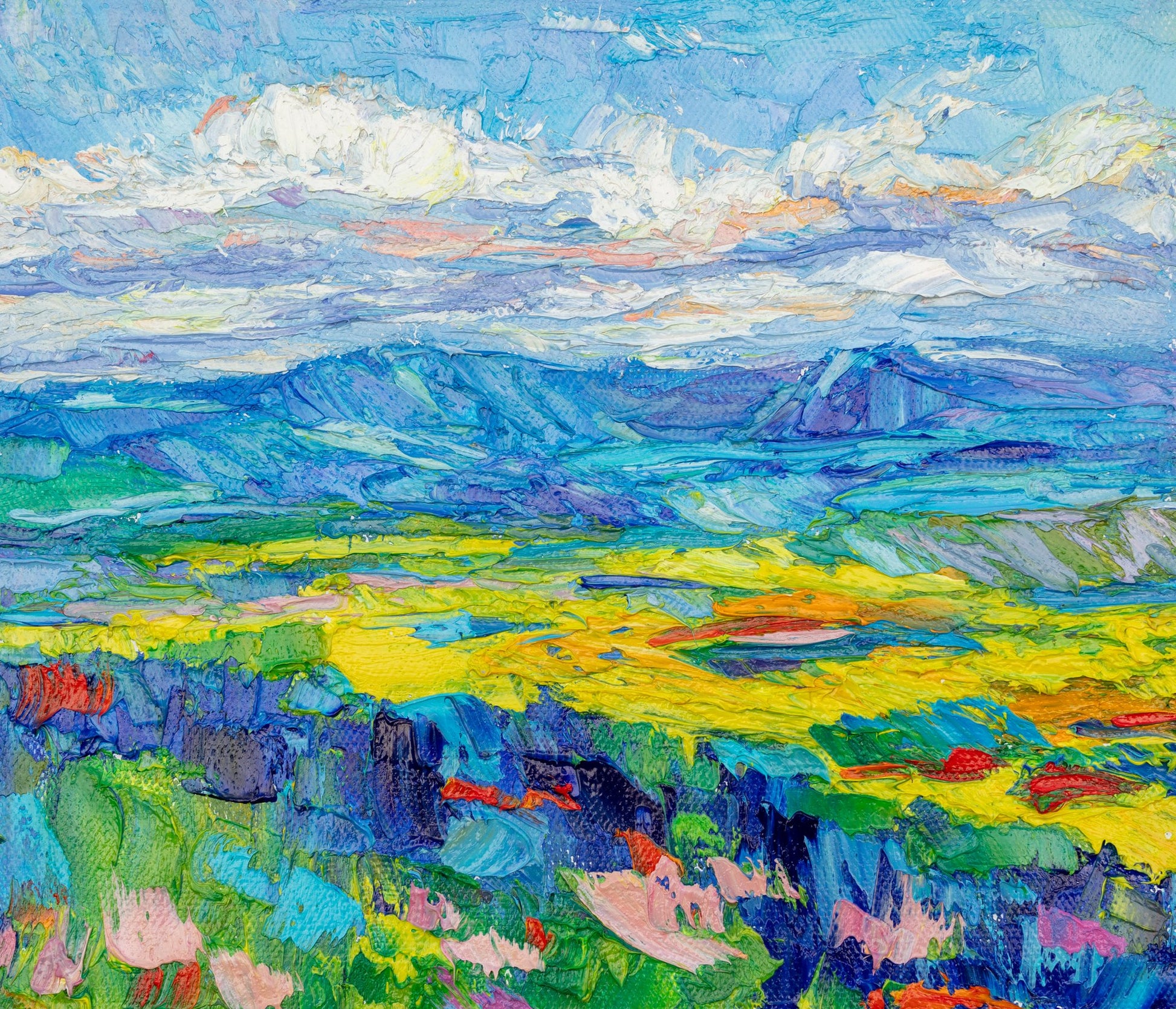 Vibrant oil painting of a mountain meadow with thick impasto texture, featuring blues, greens, and yellows; unframed canvas on neutral surface