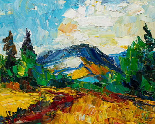 Unframed oil painting of a mountain landscape with thick impasto texture, vibrant blues, greens, and yellows, signed by artist, displayed flat on neutral surface