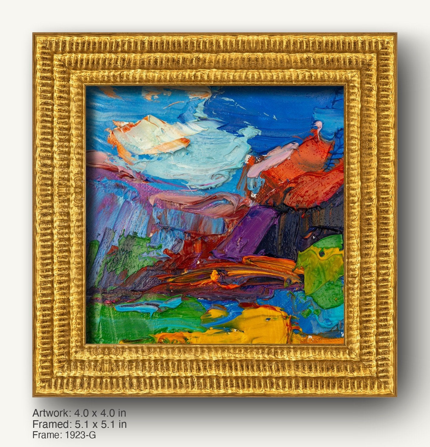Vibrant abstract oil painting in warm gold ornate frame, featuring bold blue, red, and green textures on canvas, displayed against neutral background