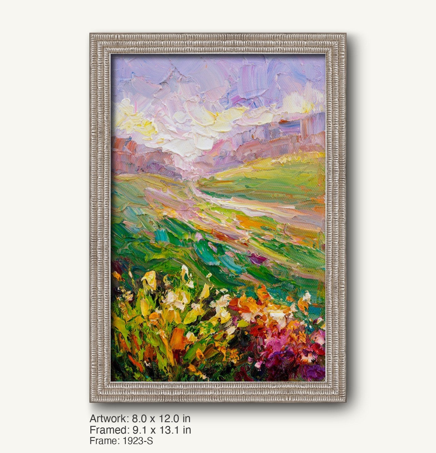 Vertical oil painting of a vibrant meadow landscape with floral foreground and rolling hills under a pastel sky, displayed in a cool silver ornate frame with textured profile