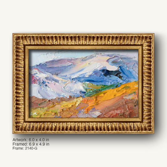 Hand-painted abstract landscape in warm gold ornate frame, featuring textured oil brushwork with blue, yellow, and white hues on canvas