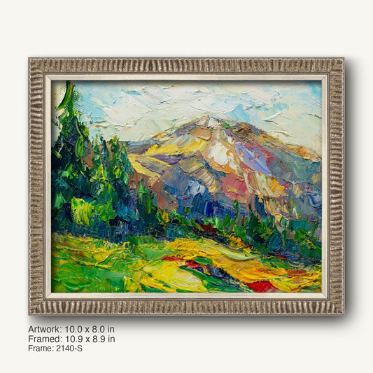 Serene mountain landscape oil painting in a textured silver frame, featuring vibrant greens, yellows, and blues with expressive brushwork and a horizontal composition.