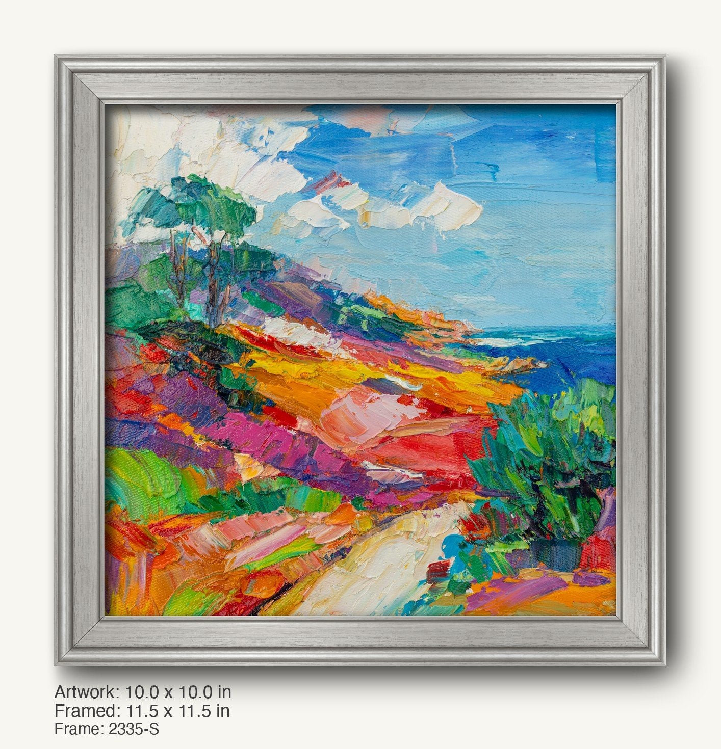 Vibrant hand-painted coastal landscape in a cool silver modern slim frame, featuring bold blues, greens, and yellows on canvas with textured brushwork
