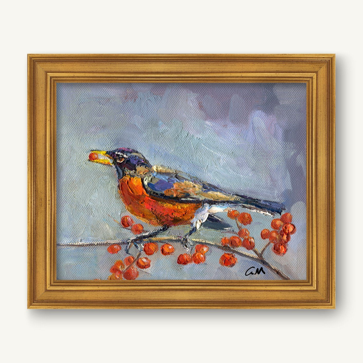 Framed oil painting of a robin perched on a branch with red berries, set against a soft blue-gray background, in a gold frame