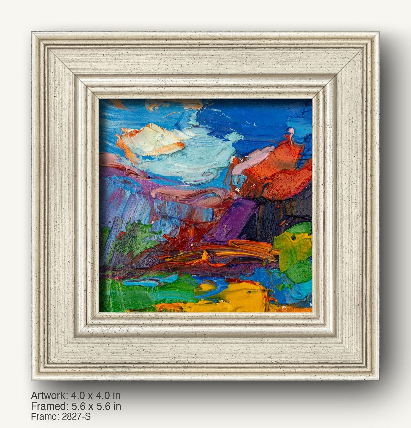 Vibrant abstract oil painting in a textured white frame, featuring bold blues, reds, and greens with tactile brushwork, set against a neutral background.