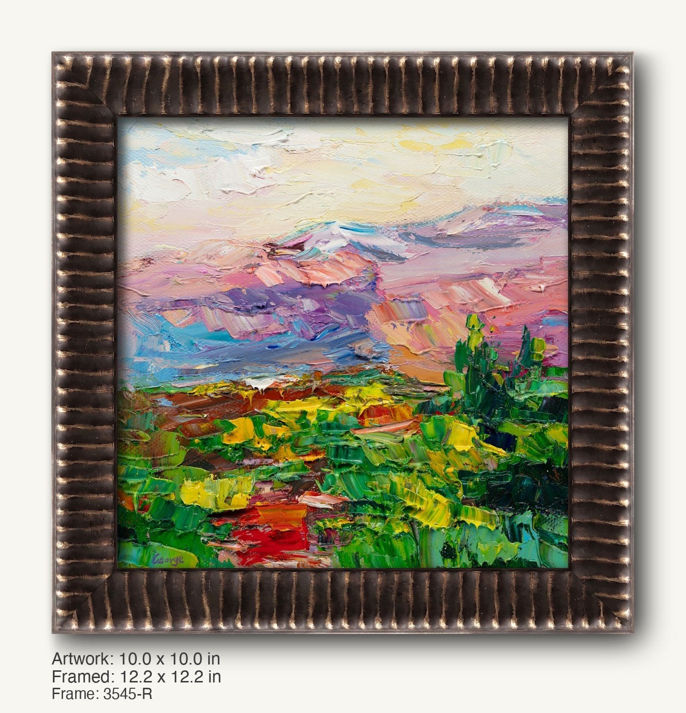 Vibrant oil painting of a desert sunset with layered mountains and greenery, framed in a dark textured ornate frame with ribbed profile