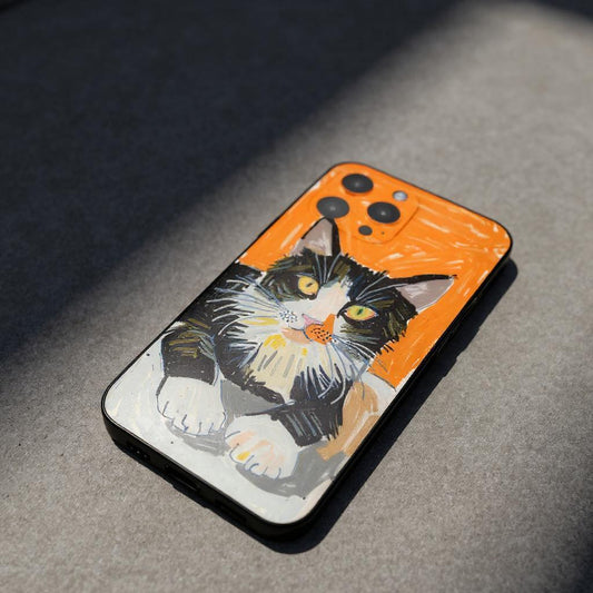 A custom pet portrait iPhone case featuring a charming illustration of a black and white cat with an orange background, creating a unique and personalized accessory.