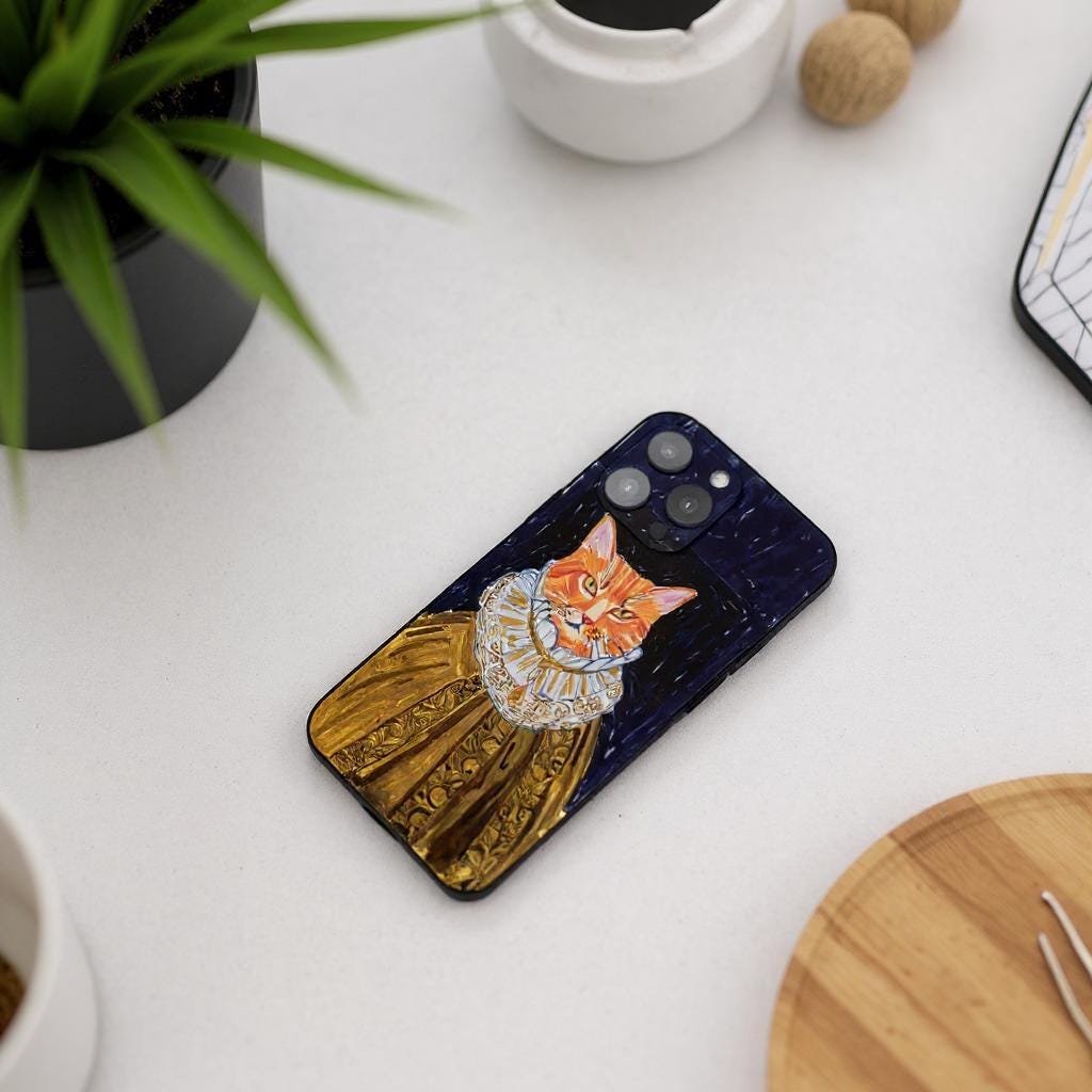 A custom pet portrait iPhone case featuring an orange tabby cat dressed in a regal golden gown with a ruffled collar, set against a dark, textured background.