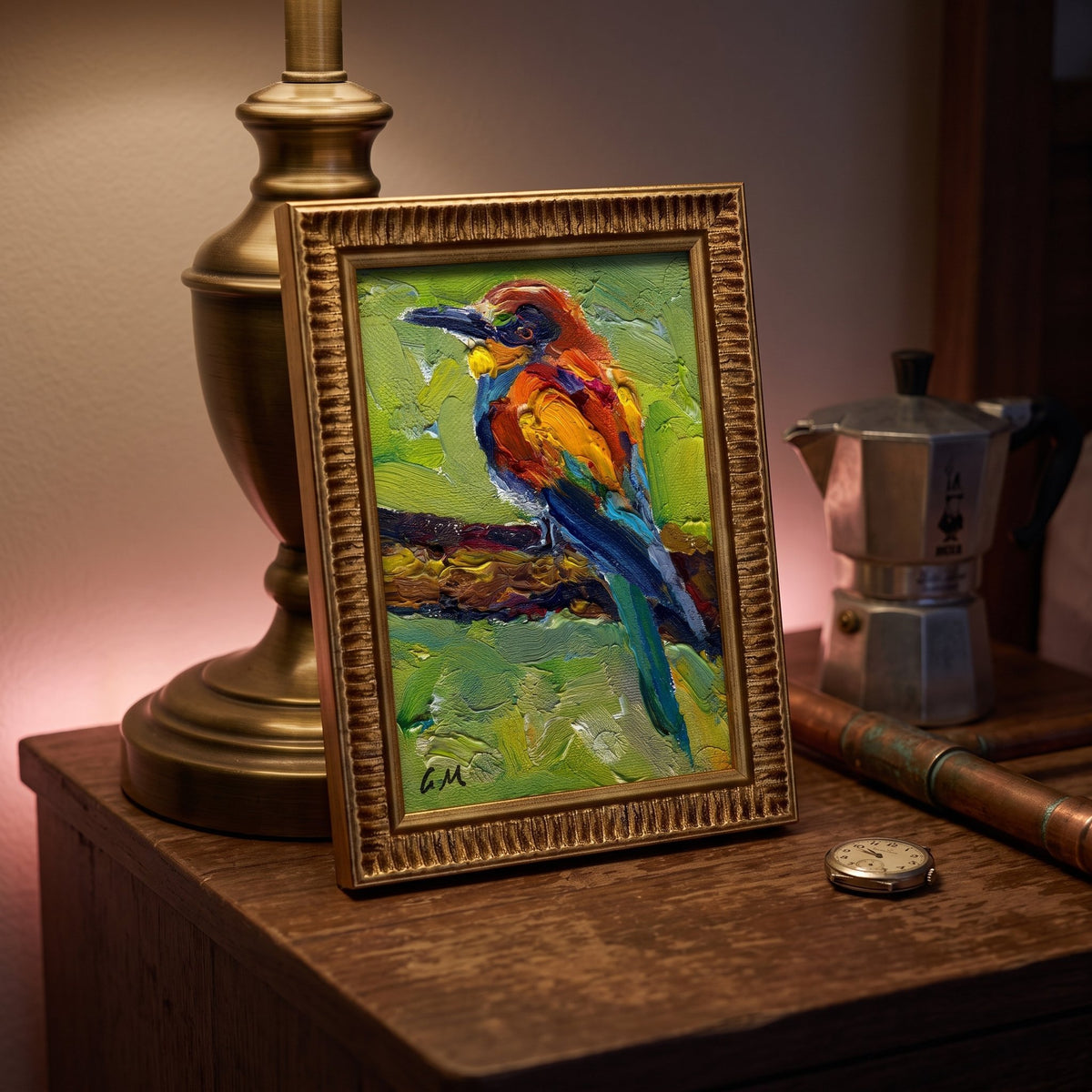 A vividly painted bird perched on a branch, rendered in thick impasto oil on canvas, rests in a gold frame atop a wooden desk beside a brass lamp and vintage coffee maker.