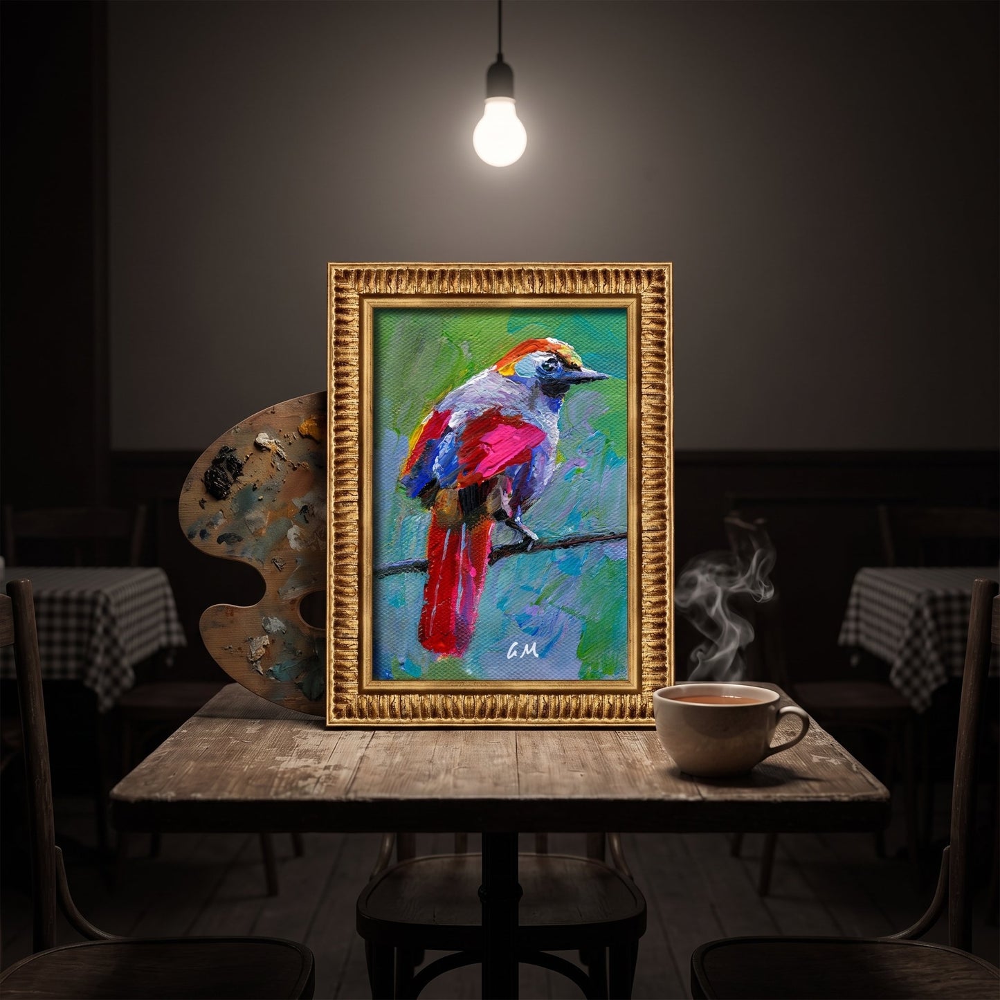 A vividly painted bird in red, blue, and green hues perches on a branch in an unframed canvas, illuminated by a single overhead bulb in a cozy café setting.