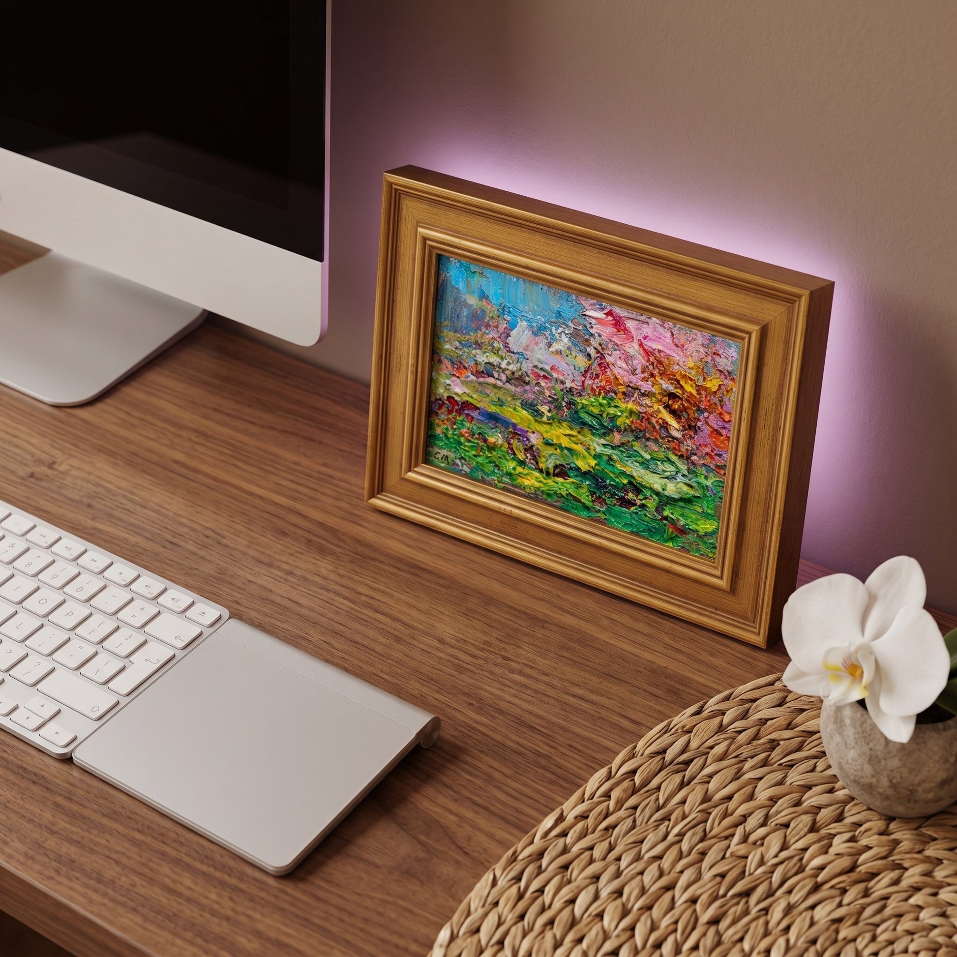 Modern home office — vibrant expressionist landscape painting adds artistic warmth and color contrast to minimalist workspace