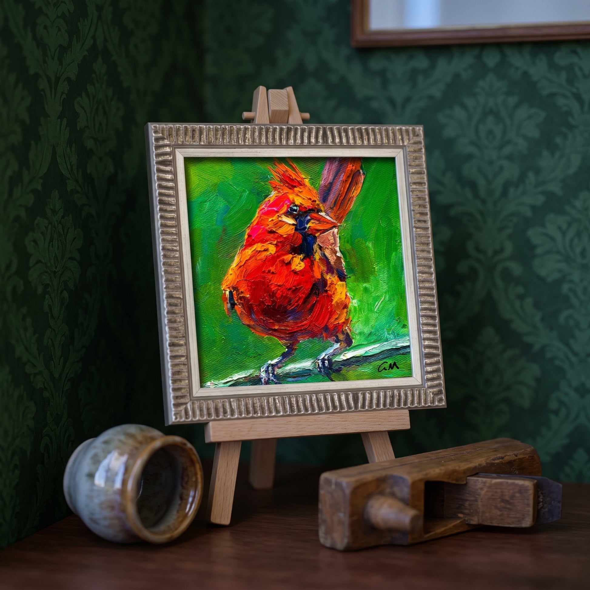 Eclectic study — Vibrant expressionist cardinal painting adds color and life to a moody, artistic space