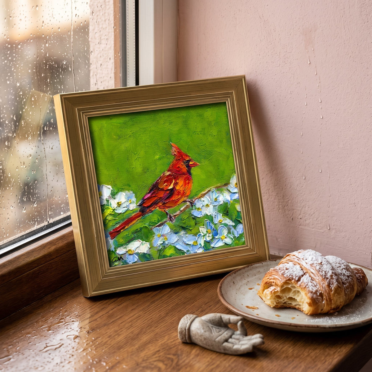Breakfast nook, rustic farmhouse — vibrant cardinal painting adds natural color and warmth to a rainlit morning scene