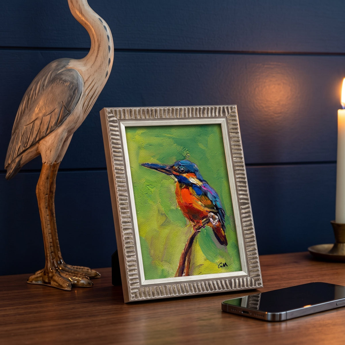 Contemporary study — Vibrant kingfisher painting adds warmth and nature-inspired charm to a moody, wood-accented space