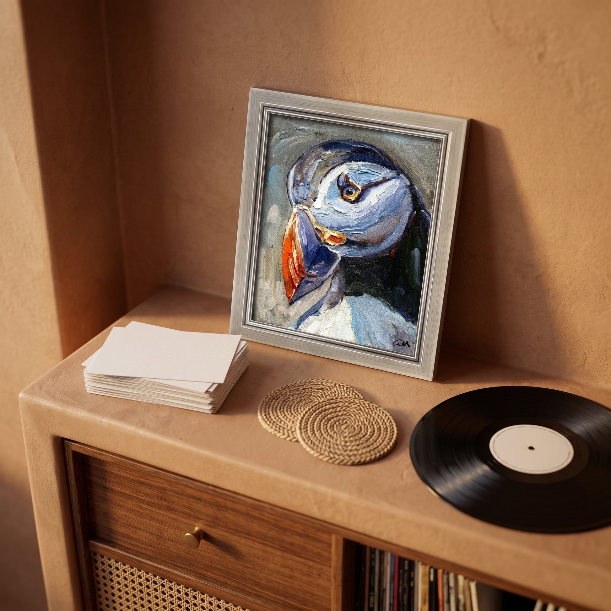 Mid-century modern study — Expressionist puffin painting adds vibrant color and texture to a warm, curated space