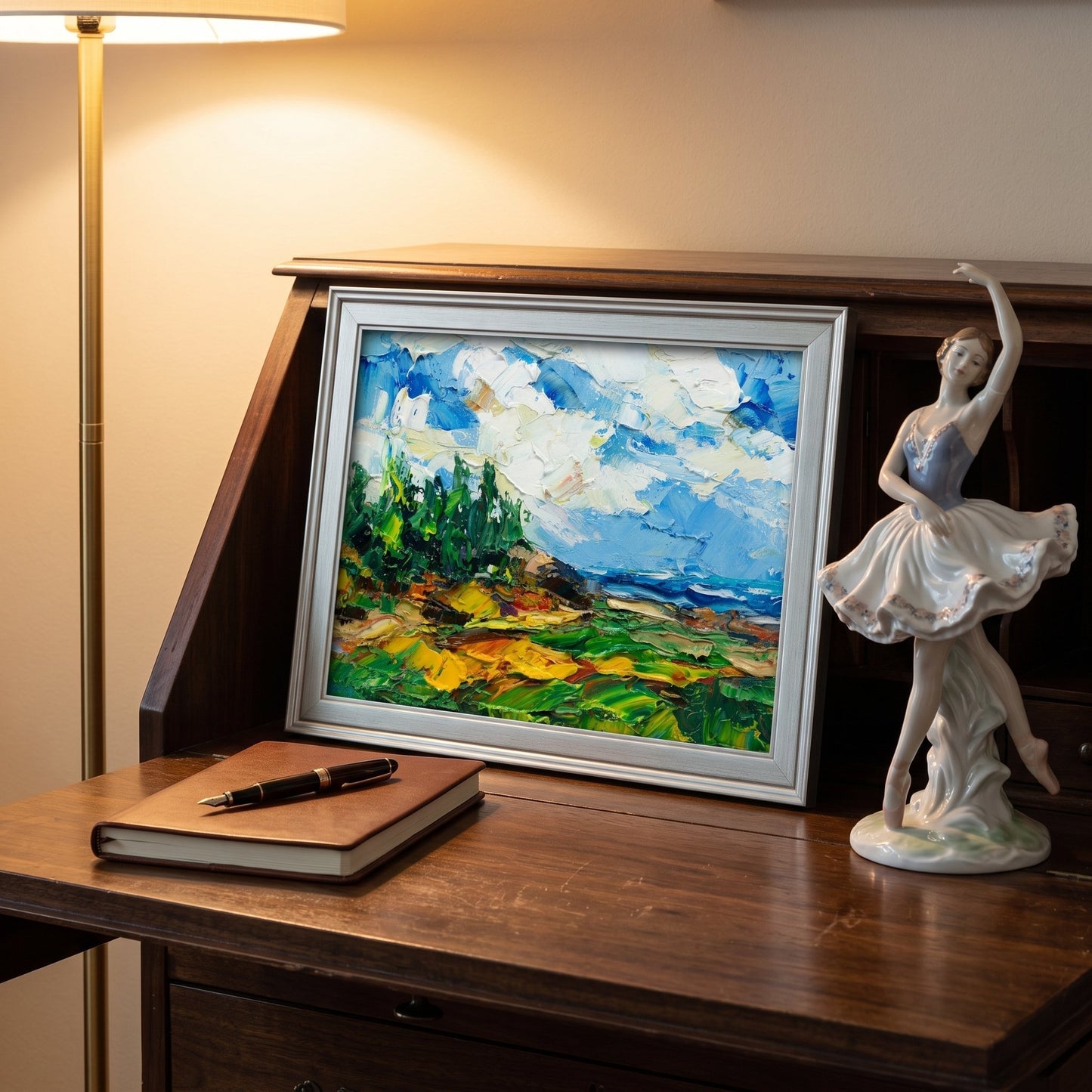Vintage study — Impressionist landscape painting adds vibrant color and artistic depth to a warm, classic workspace
