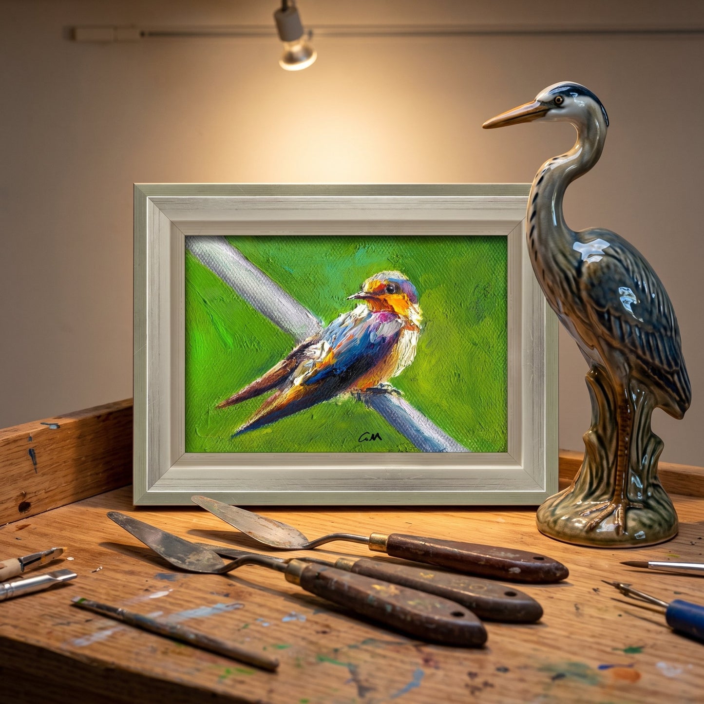 Artist's studio, rustic decor — vibrant expressionist bird painting adds color and life to creative workspace