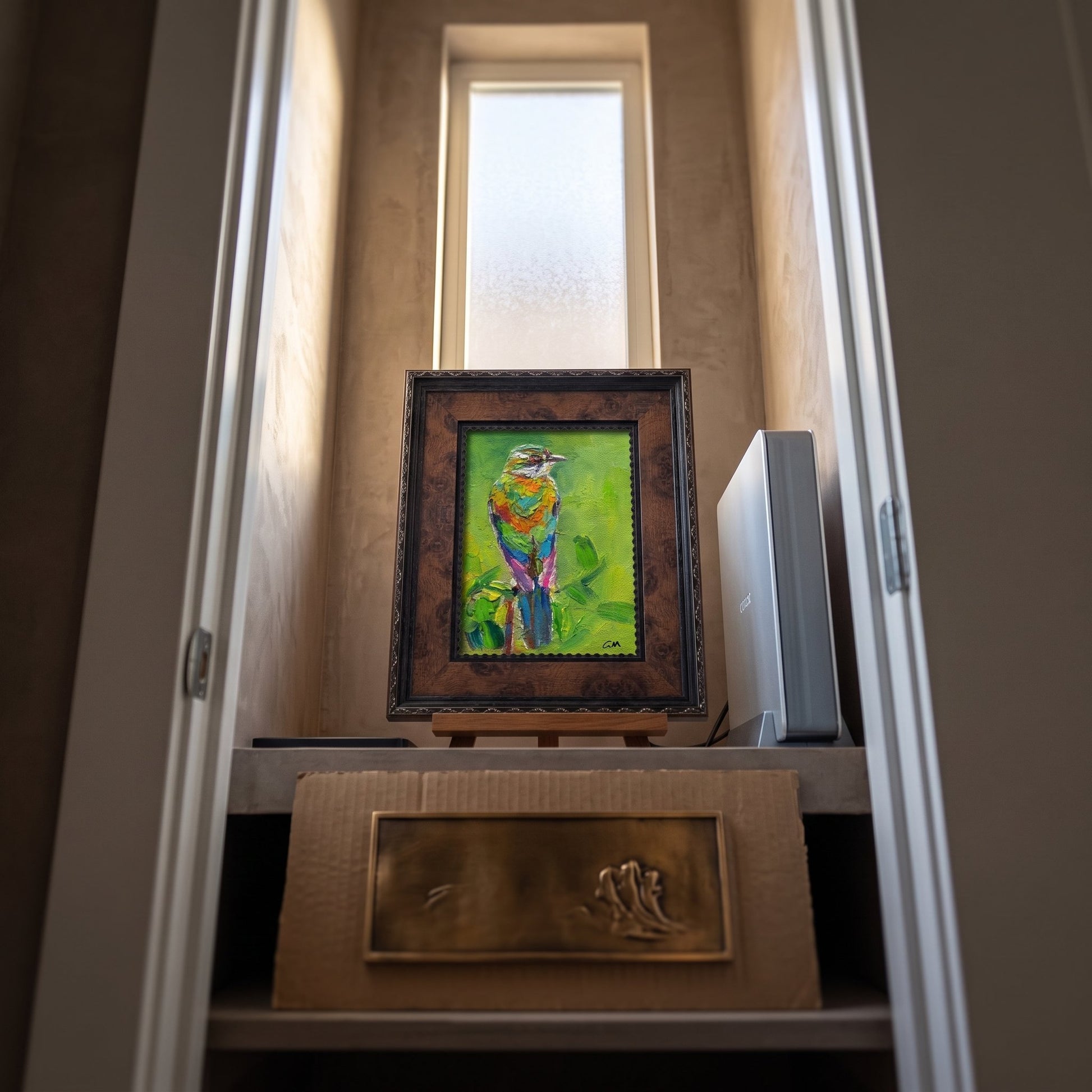 Minimalist entryway — vibrant expressionist bird painting adds color and life to a serene space
