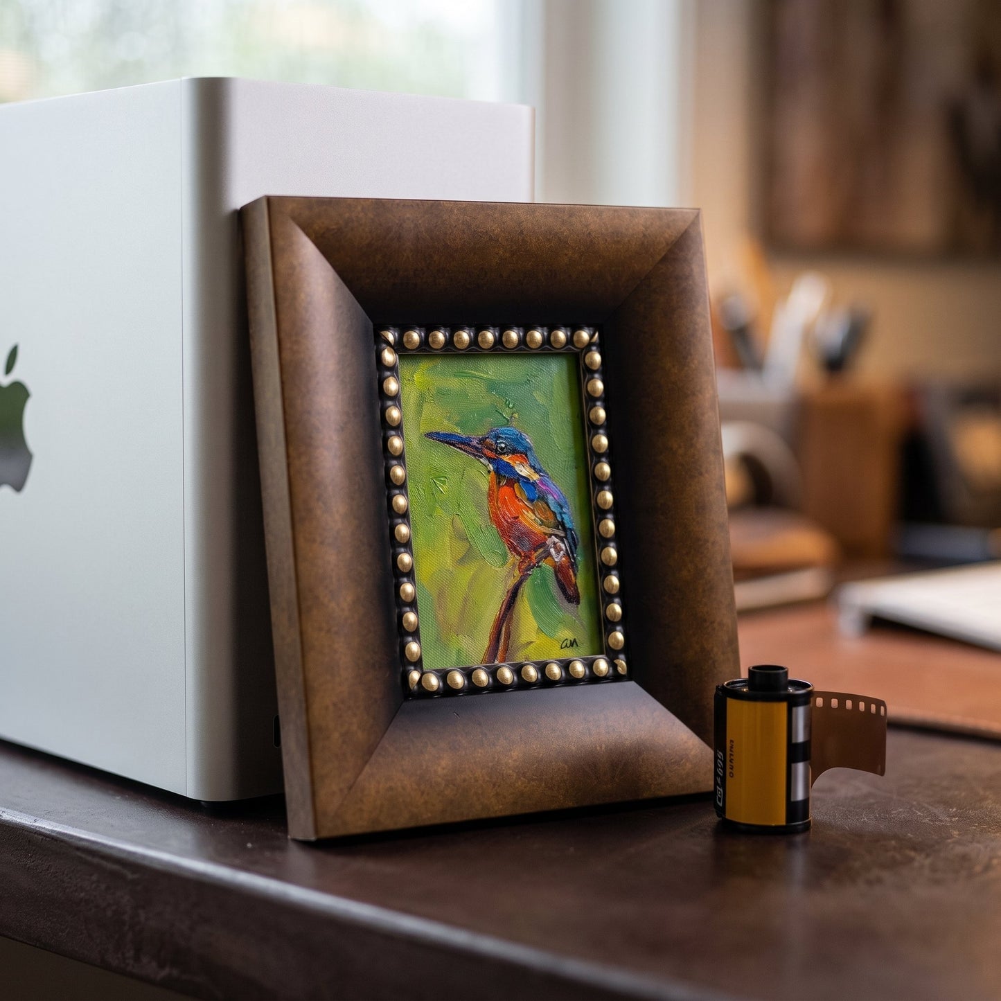 Modern home office — vibrant Impressionist bird painting adds artistic warmth and color contrast to minimalist workspace