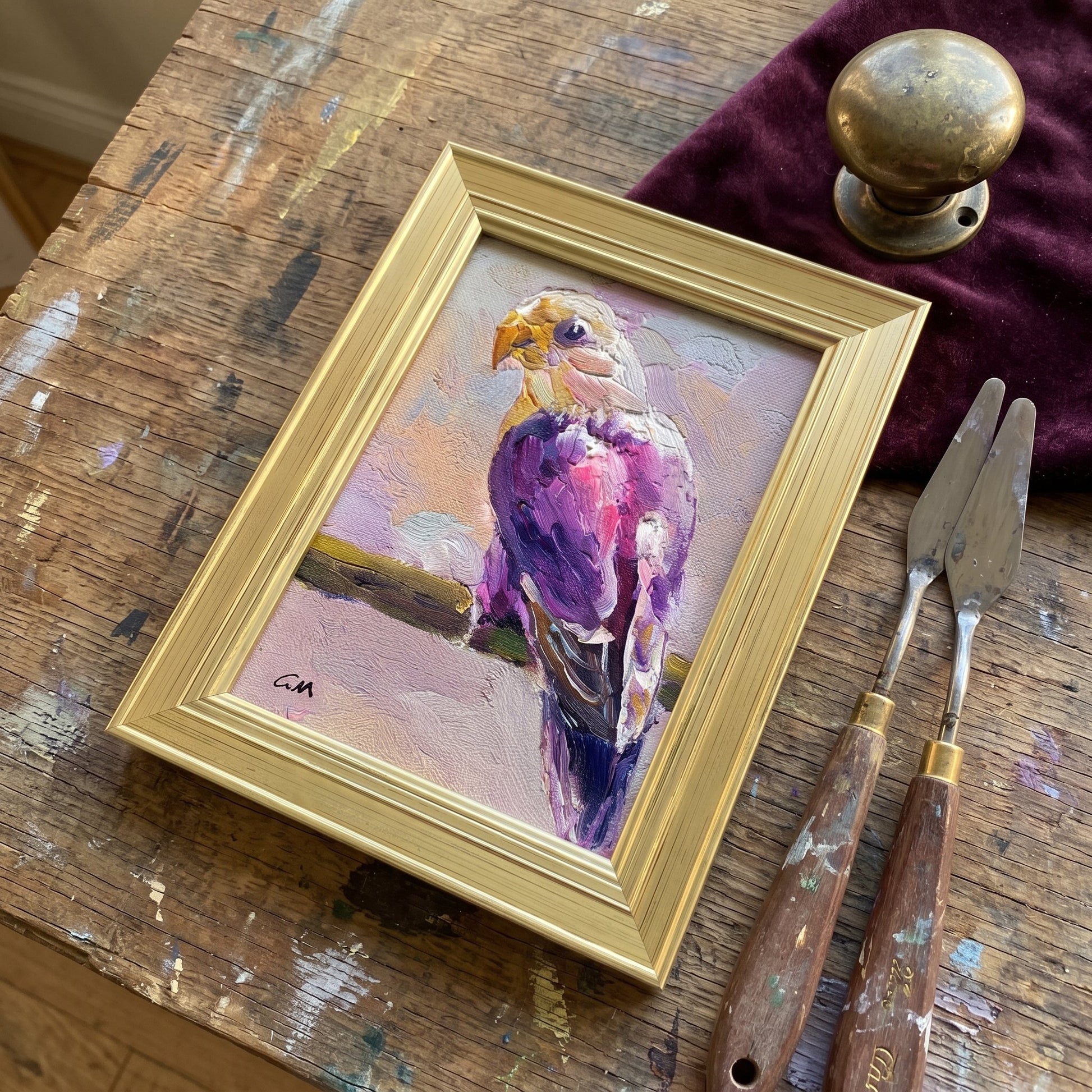 Rustic Farmhouse Studio — Expressionist bird painting adds vibrant color and artistic soul to a weathered wood workbench