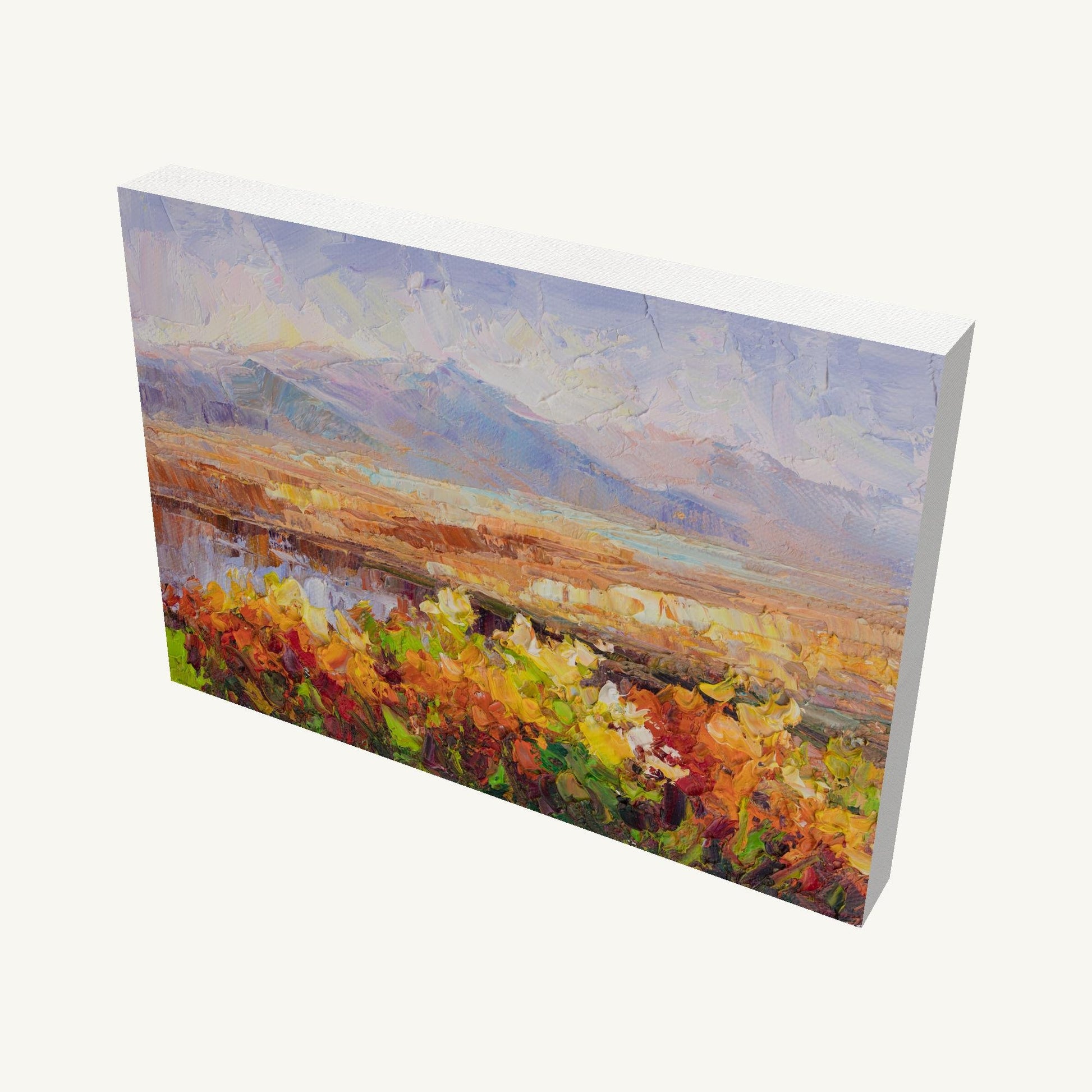 Sunset Desert Bloom oil painting on gallery-wrapped canvas, horizontal landscape with vibrant floral field and distant mountains, viewed at an angle showing depth and side edges