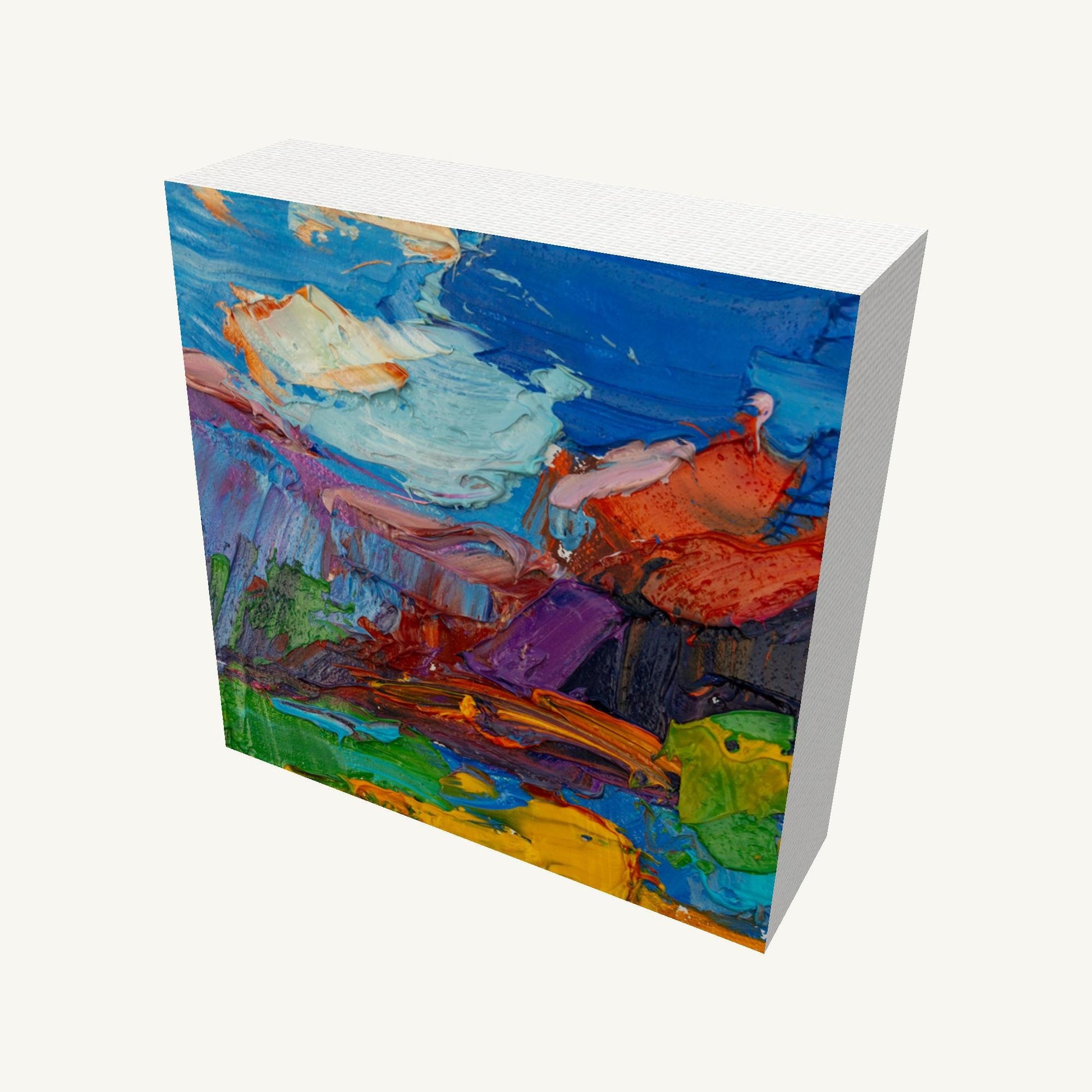 Bold abstract oil painting on gallery-wrapped canvas, 4×4 in., viewed at an angle showing textured brushwork and vibrant colors in blue, green, and red, with visible depth and side edges