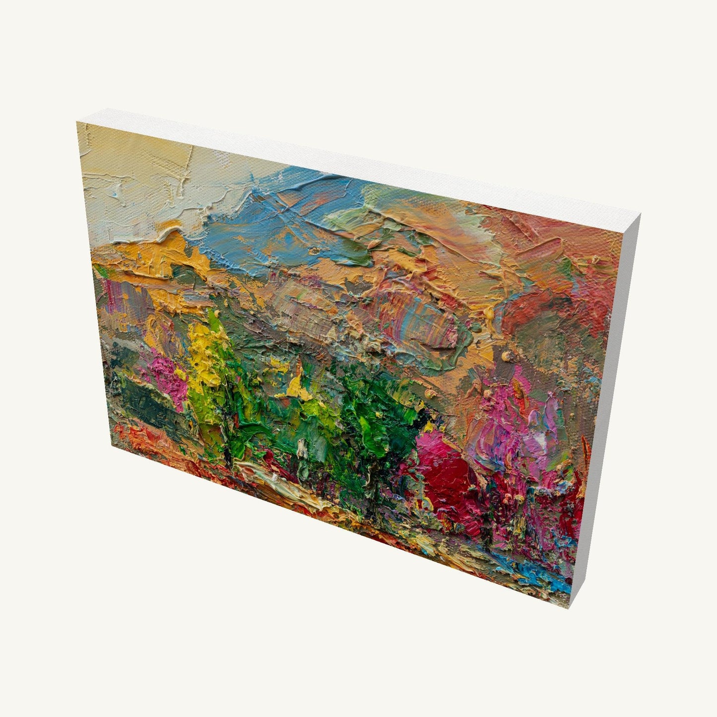 Abstract landscape oil painting on gallery-wrapped canvas, viewed at an angle, showcasing thick impasto texture and vibrant colors with visible side edges and soft shadow