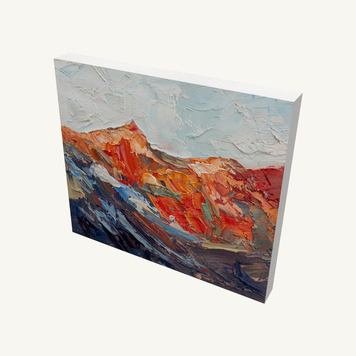 Abstract mountain landscape oil painting on gallery-wrapped canvas, viewed at an angle, showcasing textured brushwork and vibrant red, blue, and white hues with visible depth and side edges