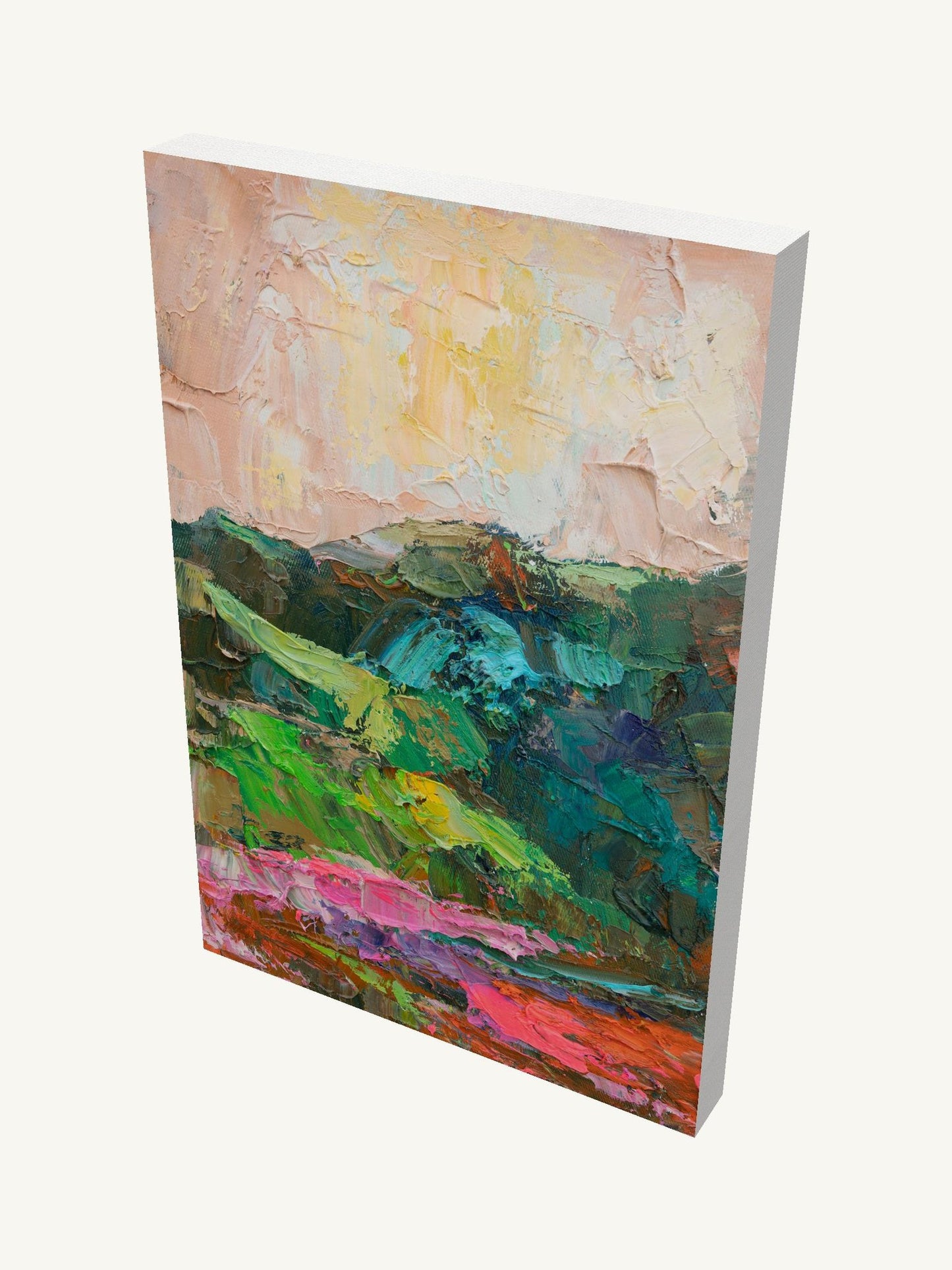 Vertical oil painting on gallery-wrapped canvas depicting a textured mountain landscape in greens, pinks, and yellows, viewed at an angle with visible depth and side edges